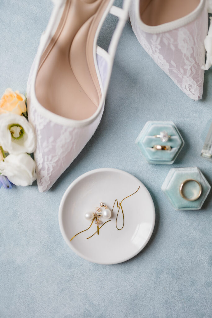 Elegant white lace wedding heels and delicate jewelry  